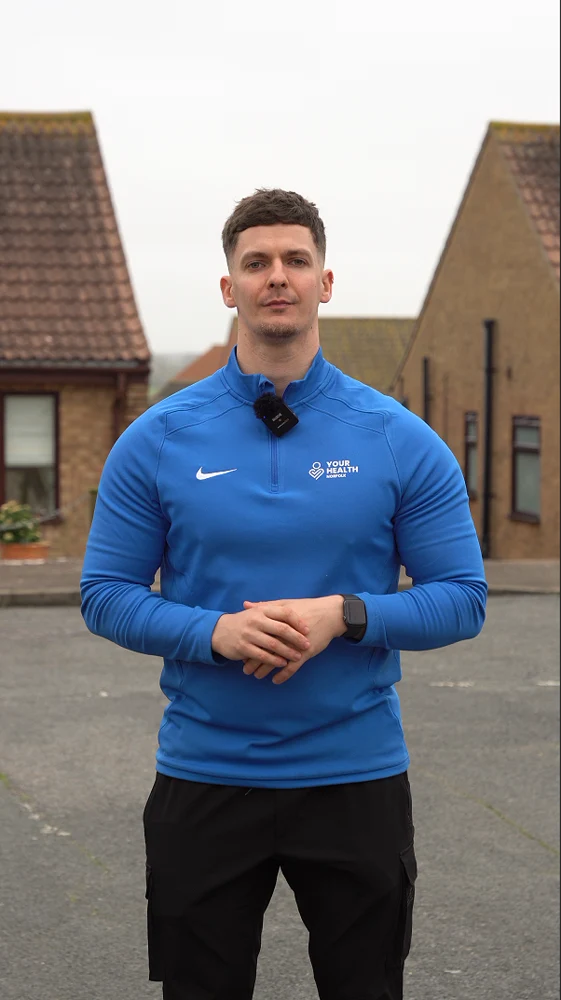 Elliot Palmer wearing his Your Health training top during filming