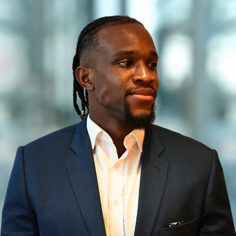 John Nwaneri wearing a navy blazer and white shirt
